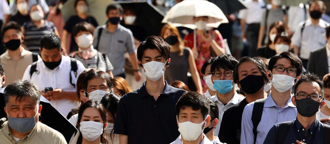 People wearing protective masks, amid the coronavirus disease (COVID-19) outbreak, make their way in Tokyo, Japan, August 6, 2021. REUTERS/Kim Kyung-Hoon
