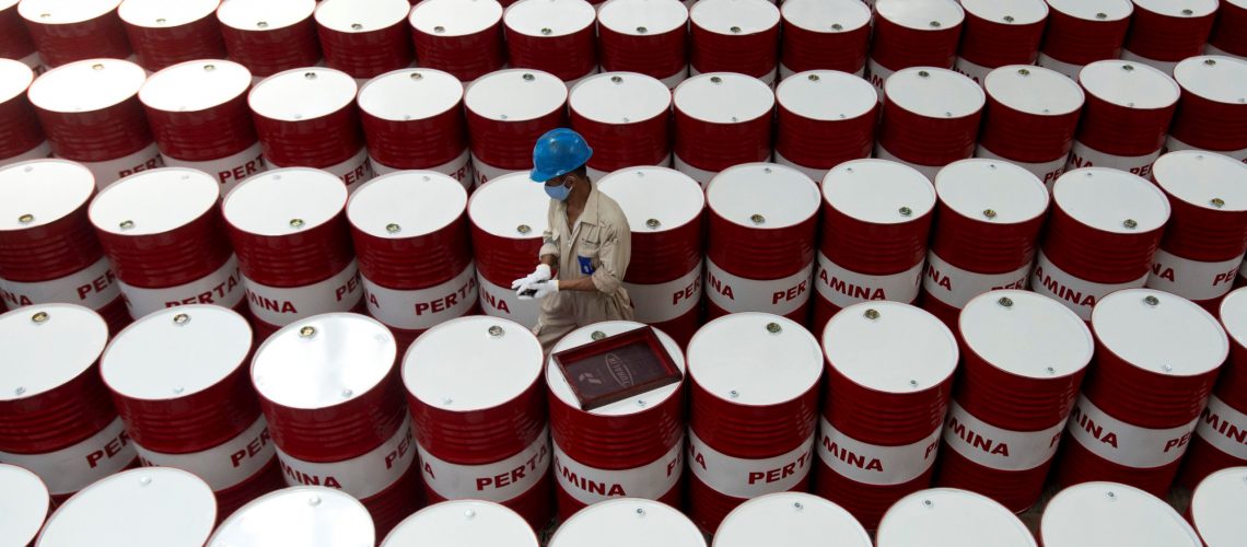 A worker prepares to label barrels of lubricant oil at the state oil company Pertamina's lubricant production facility in Cilacap, Central Java, Indonesia November 6, 2017 in this photo taken by Antara Foto. Antara Foto/Rosa Panggabean/ via REUTERS/Files